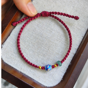 Vòng tay dây tết đỏ rượu vang mix charm Omani không gỉ xanh lam